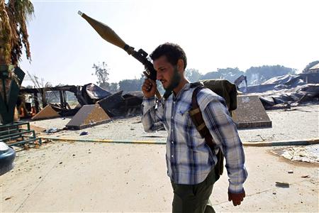 A Libyan rebel fighter carries an RPG as he walks at the Bab Al Aziziya compound in Tripoli A Libyan rebel fighter carries an RPG as he walks at the Bab Al Aziziya compound in Tripoli