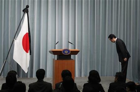 Japan's Prime Minister Naoto Kan bows to the national flag as he arrives for a news conference at his official residence in Tokyo Japan's Prime Minister Naoto Kan bows to the national flag as he arrives for a news conference at his official residence in Tokyo