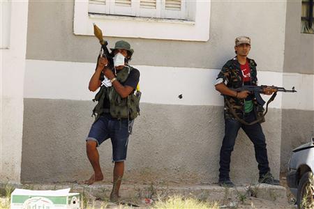 Rebel fighter points RPG launcher as they scout for snipers in final push to flush out Gaddafi's forces in Tripoli Rebel fighter points RPG launcher as they scout for snipers in final push to flush out Gaddafi's forces in Tripoli