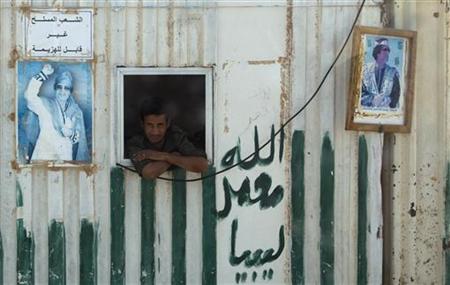 A soldier looks out of a window at a checkpoint on the road to Sirte A soldier looks out of a window at a checkpoint on the road to Sirte
