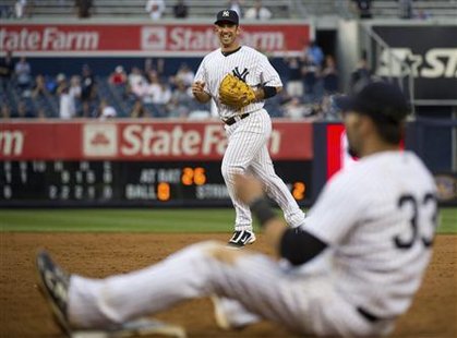 Yankees' Posada grins as he threw out Athletics' Recker for the final out in New York Yankees' Posada grins as he threw out Athletics' Recker for the final out in New York
