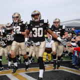 Western Michigan University players storm out of the tunnel at Waldo Stadium in 2010.
