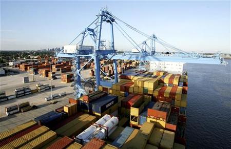 Crews load and unload consumer products at the Port of New Orleans along the Mississippi River in New Orleans, Louisiana Crews load and unload consumer products at the Port of New Orleans along the Mississippi River in New Orleans, Louisiana