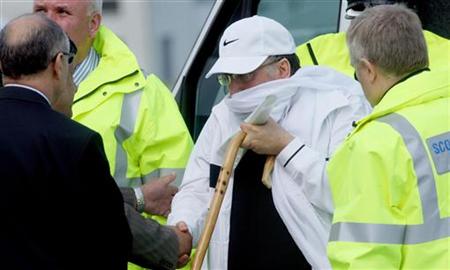 Abdel Basset al-Megrahi shakes hands with an unidentified man before boarding an aeroplane at Glasgow airport after being released from pris Abdel Basset al-Megrahi shakes hands with an unidentified man before boarding an aeroplane at Glasgow airport after being released from pris