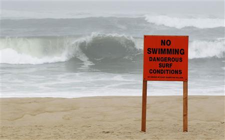 A warning sign is seen on a public beach as Hurricane Irene approaches Long Island in East Hampton Village