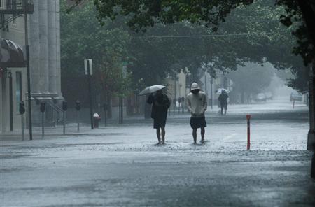 People walk in a flooded street in Hoboken in New Jersey People walk in a flooded street in Hoboken in New Jersey