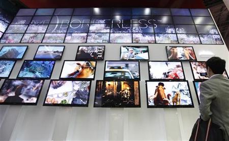 A visitor takes photos of TV sets made with LG Display flat screens at an exhibition in Goyang A visitor takes photos of TV sets made with LG Display flat screens at an exhibition in Goyang