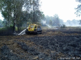 The DNR continues to extinguish a forest fire near Peshtigo in Marinette County, Aug. 27, 2011. The DNR continues to extinguish a forest fire near Peshtigo in Marinette County, Aug. 27, 2011.