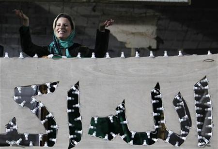 Aisha Gaddafi, daughter of Libya's leader Muammar Gaddafi,greets her father's supporters Aisha Gaddafi, daughter of Libya's leader Muammar Gaddafi,greets her father's supporters