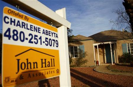 A realtor sign is displayed near a house for sale in Phoenix A realtor sign is displayed near a house for sale in Phoenix