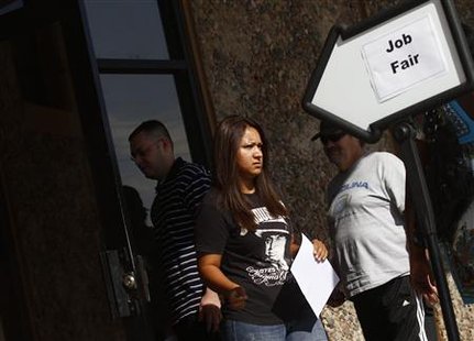 A woman exits a job fair at the Phoenix Workforce Connection as others wait to enter in Phoenix A woman exits a job fair at the Phoenix Workforce Connection as others wait to enter in Phoenix