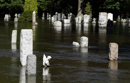 Water flows past flooded gravestones in the town of Totowa Water flows past flooded gravestones in the town of Totowa