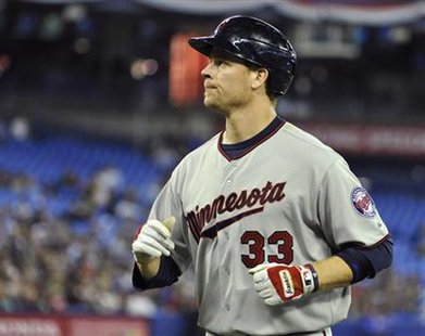 Twins batter Justin Morneau runs back to the dugout after flying out during their MLB American League game in Toronto Twins batter Justin Morneau runs back to the dugout after flying out during their MLB American League game in Toronto