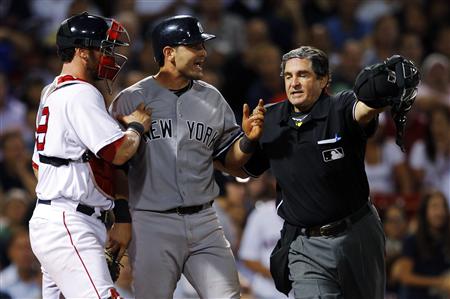 New York Yankees' Cervelli is held back by Boston Red Sox's Saltalamacchia and home plate umpire Capuano after getting hit by a pitch during New York Yankees' Cervelli is held back by Boston Red Sox's Saltalamacchia and home plate umpire Capuano after getting hit by a pitch during