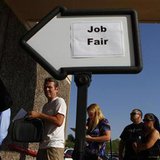 People wait in line to enter a job fair at the Phoenix Workforce Connection in Phoenix