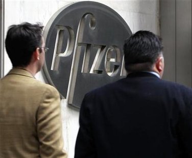 People walk past the Pfizer World headquaters in New York People walk past the Pfizer World headquaters in New York