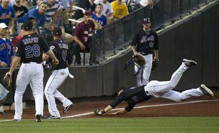 New York Mets Jason Bay dives to catch fly ball by Florida Marlins Mike Cameron in New York New York Mets Jason Bay dives to catch fly ball by Florida Marlins Mike Cameron in New York
