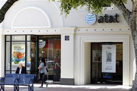 The white Apple iPhone 4 and iPad 2 are advertised in the window of an AT&T cellular store in Los Angeles The white Apple iPhone 4 and iPad 2 are advertised in the window of an AT&T cellular store in Los Angeles