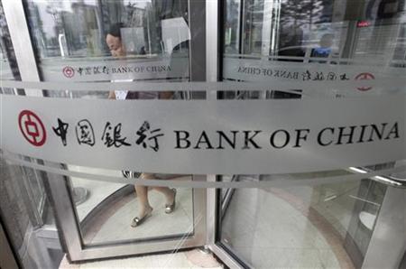 A woman leaves a branch of Bank of China in Beijing A woman leaves a branch of Bank of China in Beijing