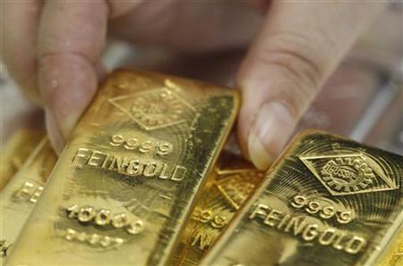 An employee picks up a gold bar at the Austrian Gold and Silver Separating Plant 'Oegussa' in Vienna An employee picks up a gold bar at the Austrian Gold and Silver Separating Plant 'Oegussa' in Vienna