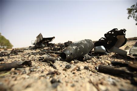 Parts of a destroyed missile lie on the ground near a truck on the road to Bani Walid Parts of a destroyed missile lie on the ground near a truck on the road to Bani Walid