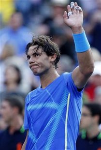 Rafael Nadal of Spain waves after his opponent Nicolas Mahut of France retired with an injury during their match at the U.S. Open tennis tou Rafael Nadal of Spain waves after his opponent Nicolas Mahut of France retired with an injury during their match at the U.S. Open tennis tou