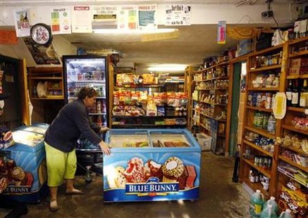 Jennifer Herzig works to clean up the shop First Stop Convenience and Repair owned by herself and her husband in Jacksonville Jennifer Herzig works to clean up the shop First Stop Convenience and Repair owned by herself and her husband in Jacksonville