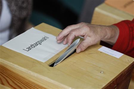 A woman casts her vote in Mecklenburg-Vorpommern state election in polling station in Neustrelitz A woman casts her vote in Mecklenburg-Vorpommern state election in polling station in Neustrelitz