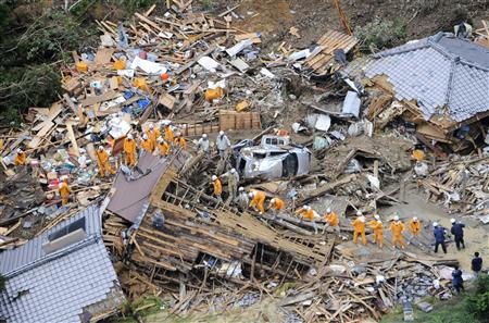 An aerial view shows firefighters searching among collapsed houses following a landslide caused by strong tropical storm Talas in Tanabe, in An aerial view shows firefighters searching among collapsed houses following a landslide caused by strong tropical storm Talas in Tanabe, in