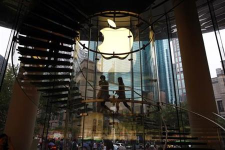 People walk inside an Apple retail store in Shanghai People walk inside an Apple retail store in Shanghai