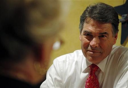 Republican presidential candidate Texas Governor Rick Perry talks to local Republican activists during lunch at Harvey's Bakery and Coffee S Republican presidential candidate Texas Governor Rick Perry talks to local Republican activists during lunch at Harvey's Bakery and Coffee S