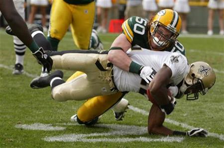 New Orleans Colston is tackled by Green Bay Packers Hawk on a five yard pass in the fourth quarter of their NFL football game at Lambeau Fie New Orleans Colston is tackled by Green Bay Packers Hawk on a five yard pass in the fourth quarter of their NFL football game at Lambeau Fie