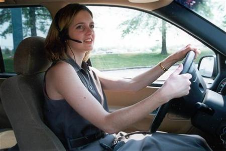 An unidentified woman uses a "hands-free" headset to make her driving easier and safer. Proposals to.. An unidentified woman uses a "hands-free" headset to make her driving easier and safer. Proposals to..