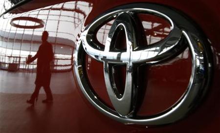 A visitor is reflected on a Toyota vehicle at the company's showroom in Tokyo