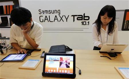 People test out Samsung Electronics' new tablet 'Galaxy Tab 10.1' during its launch ceremony in Seoul People test out Samsung Electronics' new tablet 'Galaxy Tab 10.1' during its launch ceremony in Seoul