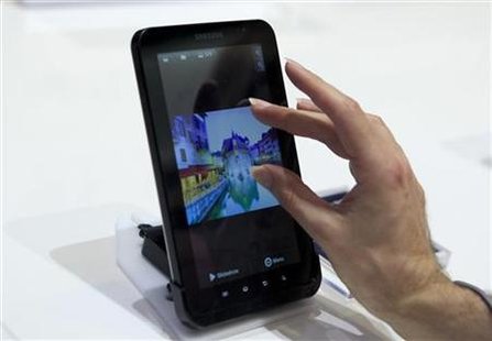 Man uses touch screen of Samsung's Galaxy Tab tablet device at IFA consumer electronics fair in Berlin Man uses touch screen of Samsung's Galaxy Tab tablet device at IFA consumer electronics fair in Berlin