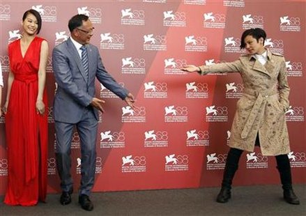 Director To poses with cast members during a photocall for their film "Duo Mingjin" at the 68th Venice Film Festival Director To poses with cast members during a photocall for their film "Duo Mingjin" at the 68th Venice Film Festival