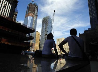 People sit in the shade next to the World Trade Center construction site at lunch time in New York People sit in the shade next to the World Trade Center construction site at lunch time in New York