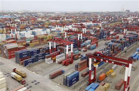 Trucks are driven into a shipping container area at Qingdao port Trucks are driven into a shipping container area at Qingdao port