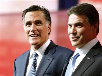 Mitt Romney stands with Rick Perry onstage during a photo opportunity before the Reagan Centennial GOP presidential primary debate in Simi V Mitt Romney stands with Rick Perry onstage during a photo opportunity before the Reagan Centennial GOP presidential primary debate in Simi V