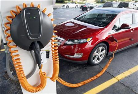 A 2012 Chevrolet Volt electric vehicle is parked at the solar-powered electric charging station designed by Sunlogics in the parking lot of A 2012 Chevrolet Volt electric vehicle is parked at the solar-powered electric charging station designed by Sunlogics in the parking lot of