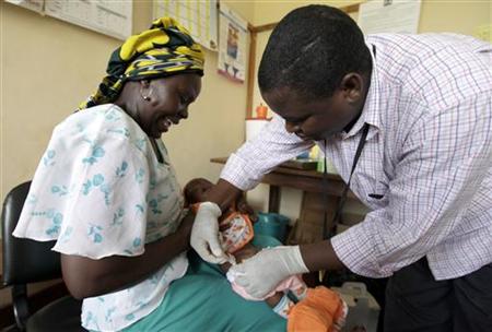 Iren Salama (L) holds her baby Pendo as it is given an injection as part of a malaria vaccine trial at a clinic in the Kenya coastal town of Iren Salama (L) holds her baby Pendo as it is given an injection as part of a malaria vaccine trial at a clinic in the Kenya coastal town of