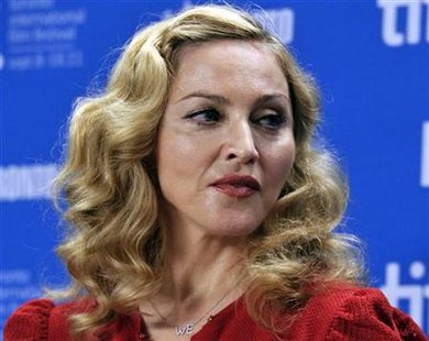 Director Madonna poses before the news conference for the film "W.E." at the 36th Toronto International Film Festival Director Madonna poses before the news conference for the film "W.E." at the 36th Toronto International Film Festival
