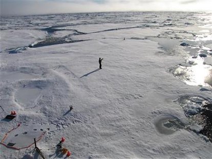 A member of a team of Cambridge scientists trying to find out why Arctic sea ice is melting so fast, walks on some drift ice 500 miles from 