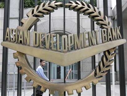 A worker walks past inside the Asian Development Bank headquarters in Manila A worker walks past inside the Asian Development Bank headquarters in Manila