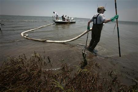 Scientist Douglas Inkley of the National Wildlife Federation pulls a broken oil boom on an island impacted by the Deepwater Horizon oil spil Scientist Douglas Inkley of the National Wildlife Federation pulls a broken oil boom on an island impacted by the Deepwater Horizon oil spil