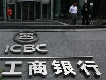 People walk past a company logo of the Industrial and Commercial Bank of China (ICBC) outside one of its branches in Beijing People walk past a company logo of the Industrial and Commercial Bank of China (ICBC) outside one of its branches in Beijing