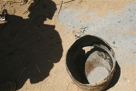 A U.S. Marine from 3rd Battalion, 6th Marines looks at a barrel which was used for an IED and its powder after it exploded, during a patrol A U.S. Marine from 3rd Battalion, 6th Marines looks at a barrel which was used for an IED and its powder after it exploded, during a patrol