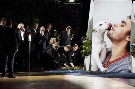 Mourners place flowers next to the portrait of Swedish ice hockey goalkeeper Stefan Liv during his memorial service in Jonkoping Mourners place flowers next to the portrait of Swedish ice hockey goalkeeper Stefan Liv during his memorial service in Jonkoping