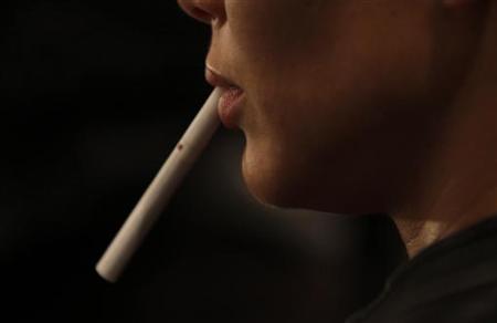 A model holds an unlit cigarette in her mouth backstage before the Zang Toi Spring 2011 collection during New York Fashion Week A model holds an unlit cigarette in her mouth backstage before the Zang Toi Spring 2011 collection during New York Fashion Week
